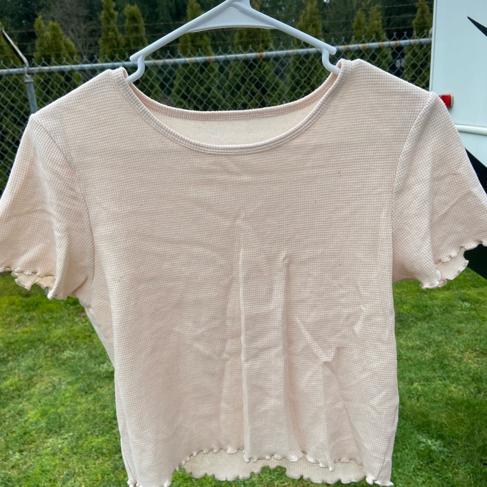 American Eagle cream frilly top, tight fitting
